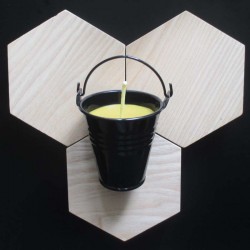 Beeswax candle in black bucket